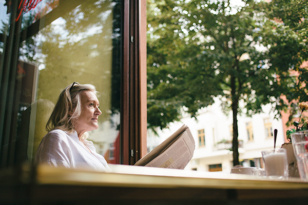 Older woman reading the newspaper